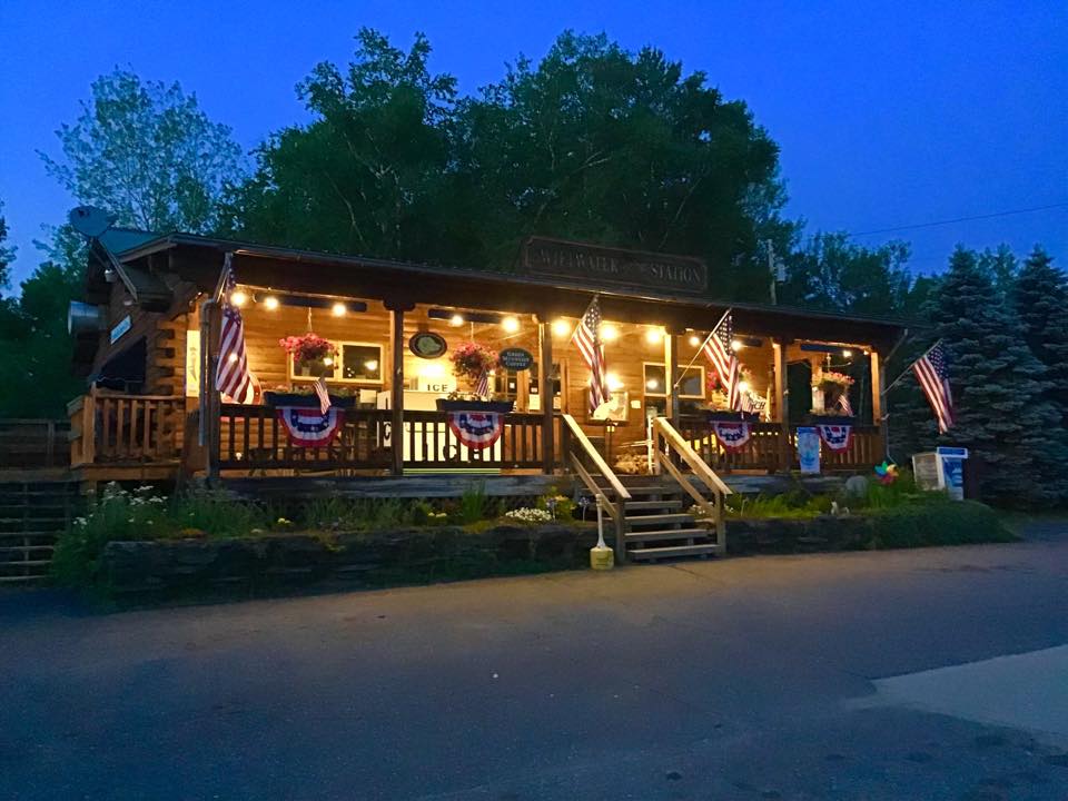 Swiftwater Way Station lit up at night in Bath NH